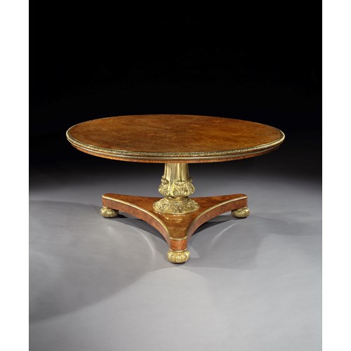 A GEORGE IV BRASS MOUNTED PARCEL GILT AMBOYNA CENTRE TABLE
